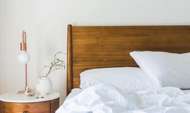 Large well lit bedroom with plush carpet floors and large windows.