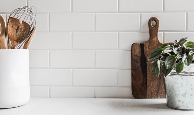 Spacious and well lit kitchen with wood floors and stainless steel appliances