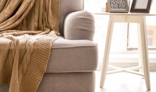 Spacious and well lit living room with wood flooring, large windows and open access to the kitchen.